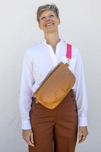 Woman wearing the Paquette Bag sewing pattern from Christine Haynes on The Fold Line. A cross body bag pattern made in cotton, linen, denim, wool, corduroy, canvas, upholstery, leather, or vinyl fabric, featuring a full lining and zipper closure.