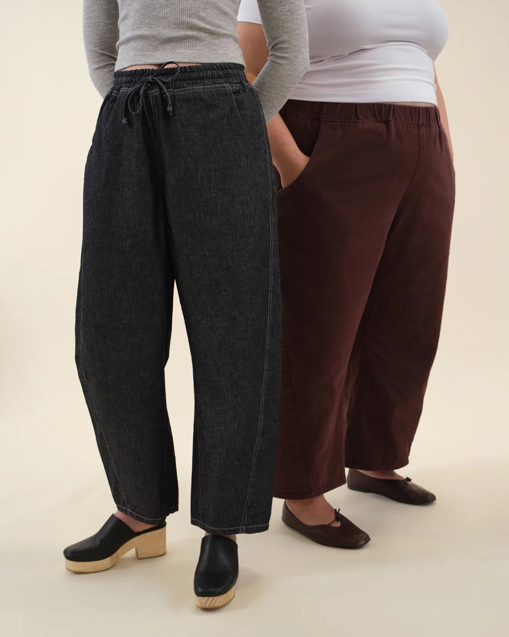 Women wearing the Parker Pants sewing pattern from BF Patterns on The Fold Line. A trousers pattern made in medium weight denim, cotton twill, or canvas fabric, featuring a twisted side seam, subtle barrel leg, and elastic waist with optional drawstring.
