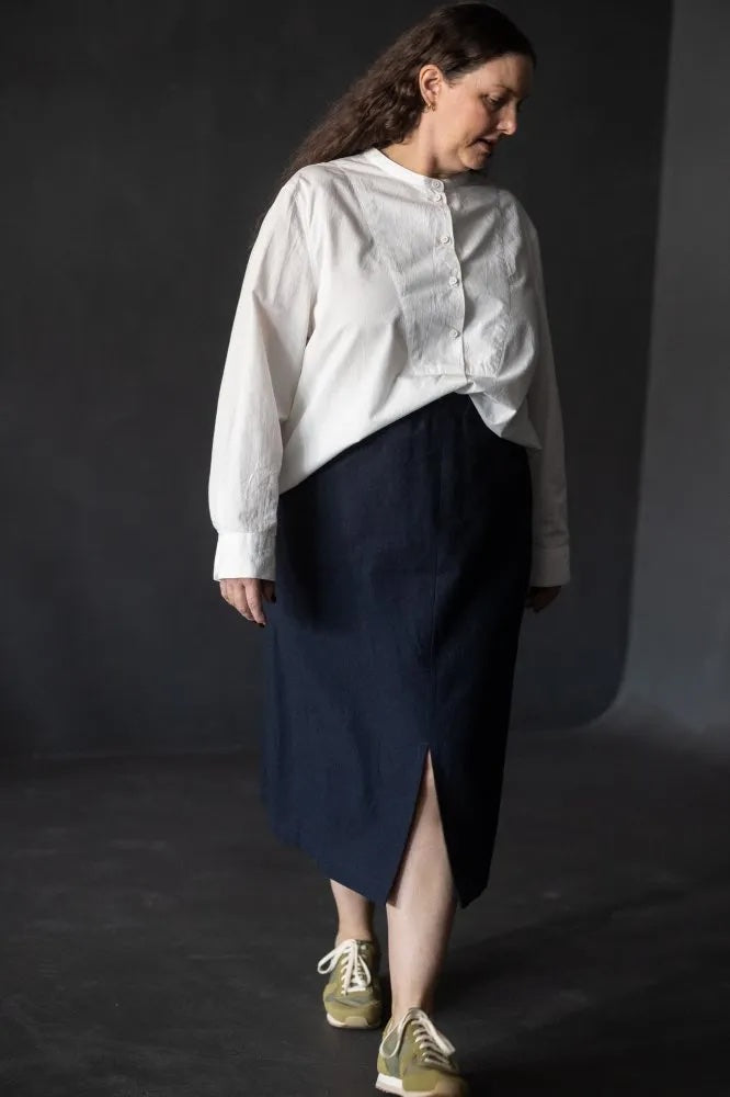 Woman wearing the Penna Skirt sewing pattern from Merchant & Mills on The Fold Line. A skirt pattern made in linen, cotton poplin, tencel, Indian handloom, or 4-6 oz denim fabric, featuring a deep elasticated waistband, front split, and in-seam pockets.