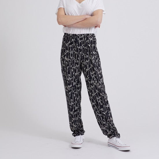 Woman wearing the Philippe Pants sewing pattern from Coralie Bijasson on The Fold Line. A pants pattern made in viscose crepe, silk satin, or cotton fabric, featuring an elasticised waist, front pleats, and slant pockets.