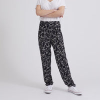 Woman wearing the Philippe Pants sewing pattern from Coralie Bijasson on The Fold Line. A pants pattern made in viscose crepe, silk satin, or cotton fabric, featuring an elasticised waist, front pleats, and slant pockets.