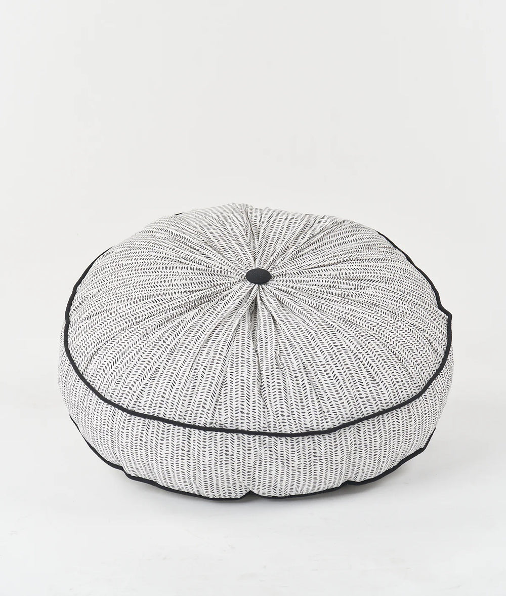 The Piped Floor Cushion sewing pattern from Sew Over It on The Fold Line. A cushion pattern made in cotton drill, canvas, or upholstery fabric, featuring a round shape, gathered top and bottom, piped edges, and a zip.