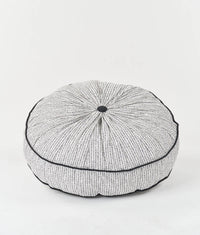 The Piped Floor Cushion sewing pattern from Sew Over It on The Fold Line. A cushion pattern made in cotton drill, canvas, or upholstery fabric, featuring a round shape, gathered top and bottom, piped edges, and a zip.