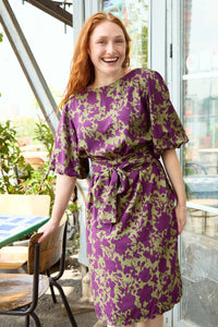 Woman wearing the Pippa Dress 2.0 sewing pattern from Atelier Jupe on The Fold Line. A dress pattern made in viscose, cotton, tencel, double gauze, or linen fabric, featuring mid-length puffed sleeves, a wrap belt, side pockets, and knee length.