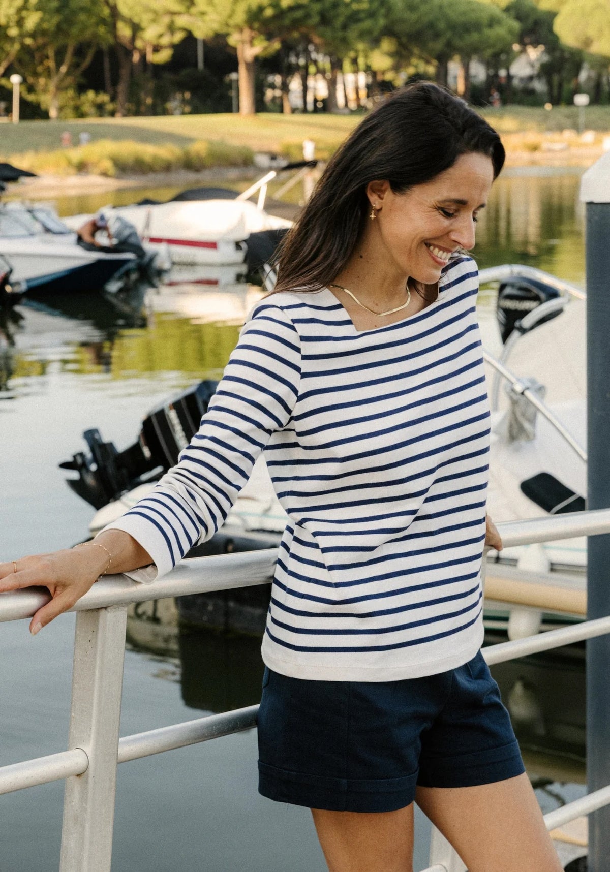 Woman wearing the Pirate Breton Top sewing pattern from Maison Fauve on The Fold Line. A top pattern made in knit fabric, featuring a square neckline, shoulder pleats, and long sleeves.