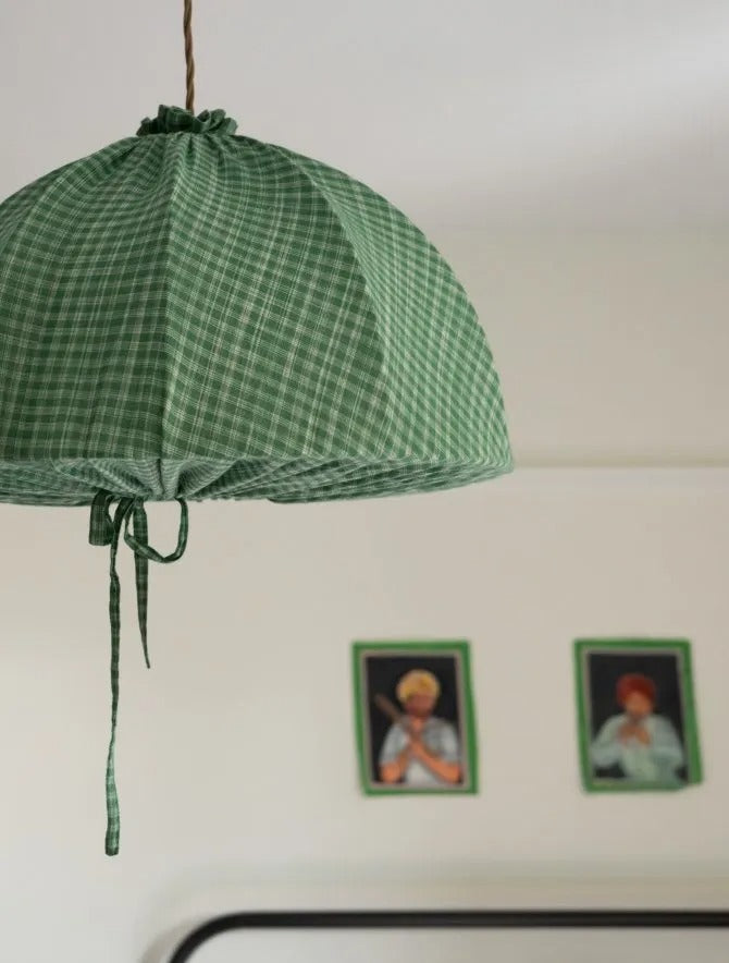 The Pomegranate Lampshade Cover sewing pattern from Merchant & Mills on The Fold Line. A lampshade pattern made in linen, cotton, or hemp fabric, featuring a domed shape, drawstrings, and ruffle.