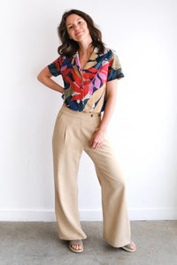 Woman wearing the Ponderosa Pants sewing pattern from Allie Olson on The Fold Line. A trousers pattern made in linen, viscose, or tencel fabric, featuring a relaxed fit, pleats, pockets, side snap closure, elasticated back waist, and wide leg.