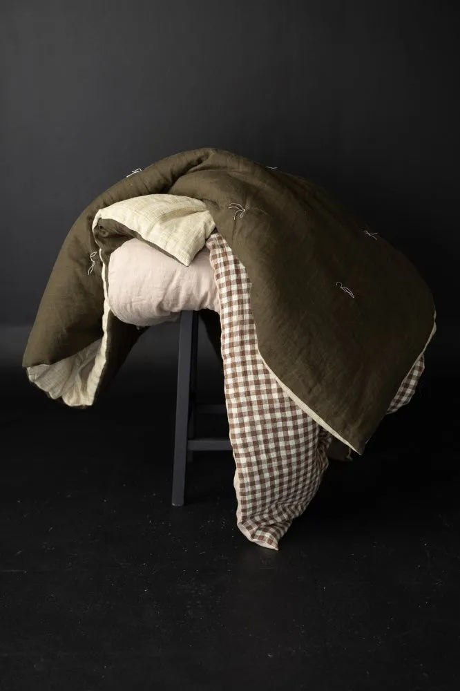 The Quilt and Sofa/Bed Topper sewing pattern from Merchant & Mills on The Fold Line. A quilt pattern made in linen, cotton double gauze, brushed cotton, Indian handloom, or cotton block print fabric, featuring linen thread or fabric ties.