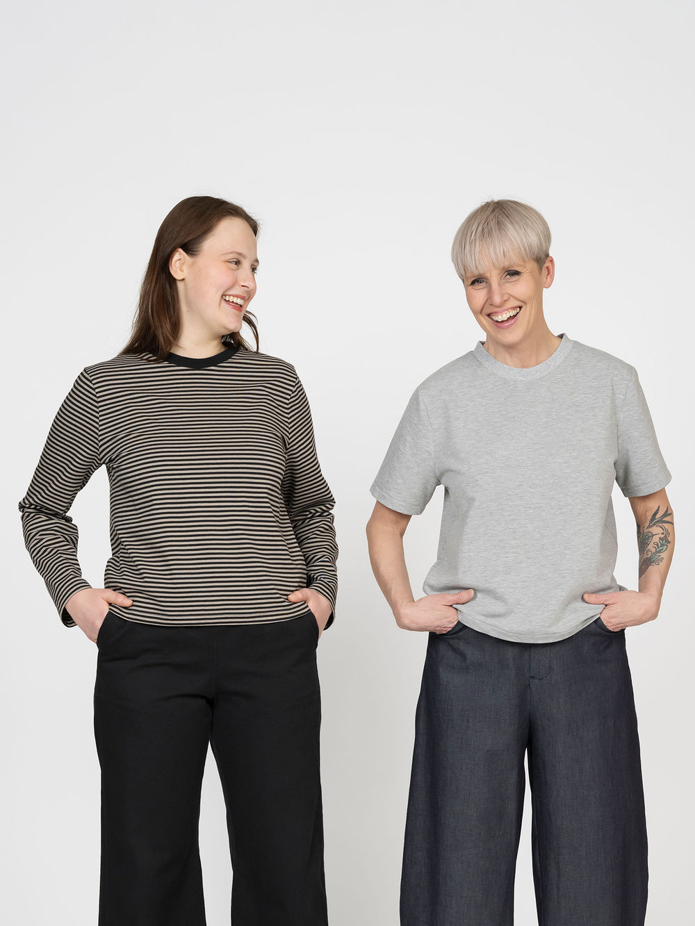 Women wearing the Regular Fit T-shirt sewing pattern from The Assembly Line on The Fold Line. A top pattern made in jersey fabric, featuring a relaxed unisex fit, round neckline, and short or long sleeves.