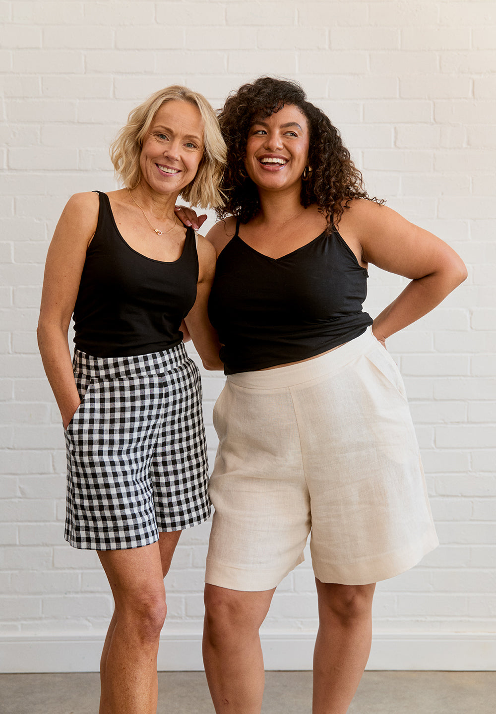 Women wearing the Ren Shorts sewing pattern from Fabric Godmother on The Fold Line. A shorts pattern made in cotton, denim, or linen fabric, featuring a high rise, side pockets, concealed side zip, and mid-thigh or Bermuda length.