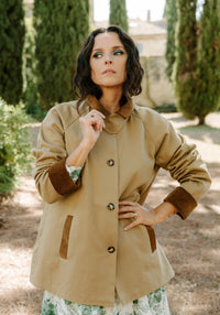 Woman wearing the Roman Overcoat sewing pattern from Maison Fauve on The Fold Line. A coat pattern made in cotton gabardine, wool, or tweed fabric, featuring a contrast collar, detachable collar tab, button front, raglan sleeves with contrast cuffs, welt pockets, and hip length.