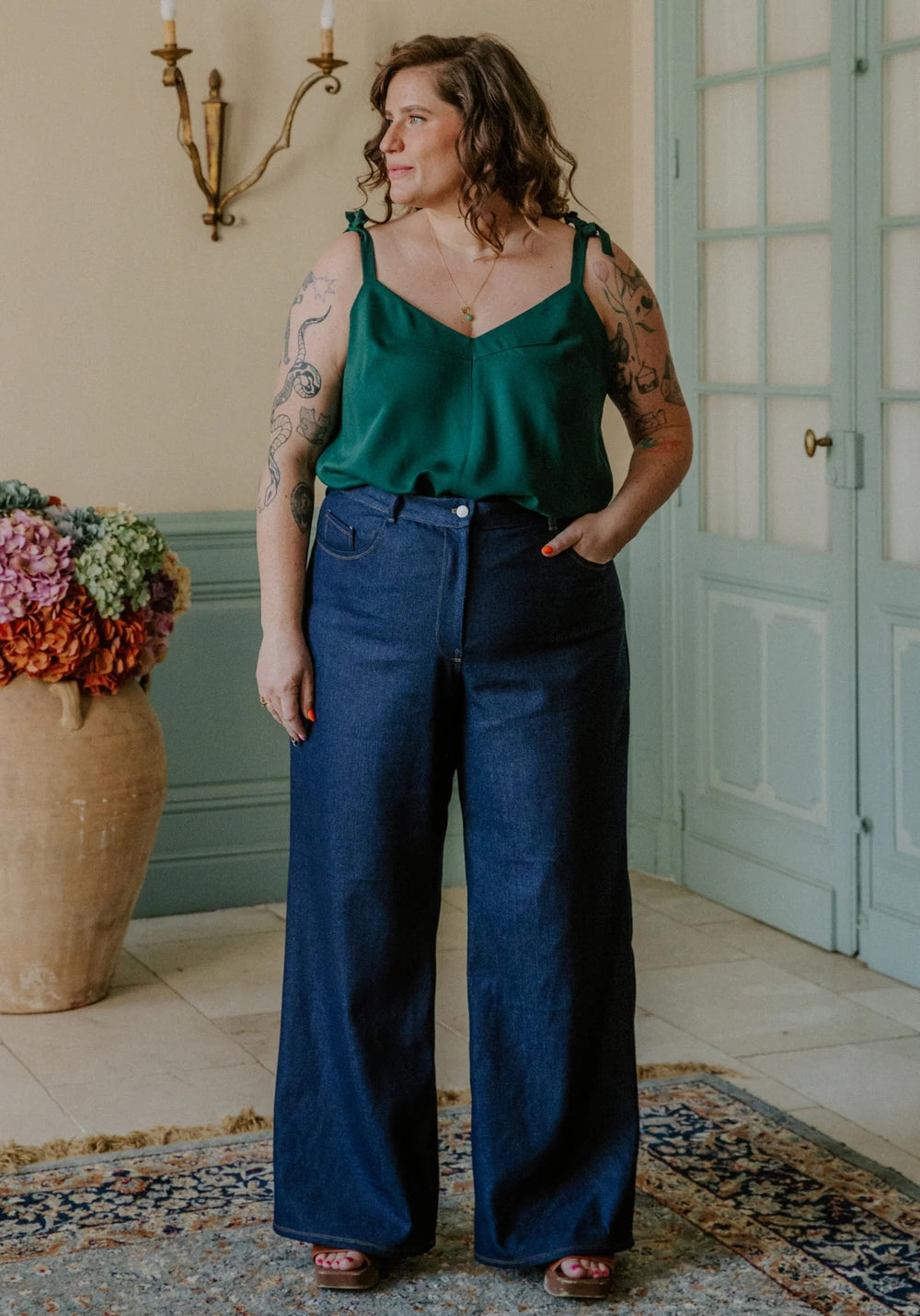 Woman wearing the Ronsard Jeans sewing pattern from Maison Fauve on The Fold Line. A jeans pattern made in denim, gabardine, or cotton twill fabric, featuring a mid rise, fly front zip, wide legs, and topstitching.