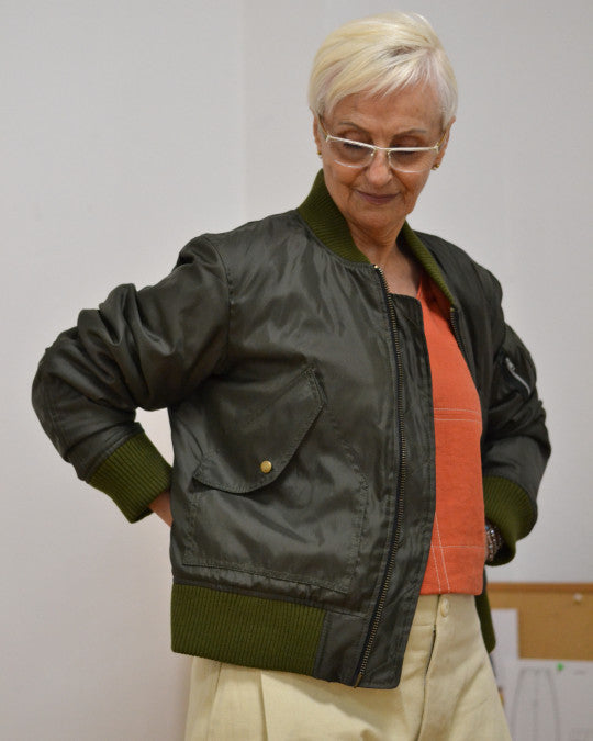 Woman wearing the Rosell Bomber sewing pattern from Pauline Alice on The Fold Line. A fully lined and padded bomber jacket pattern made in cotton, gabardine, nylon, or twill fabric, featuring ribbed trim at the collar, cuffs and waistband, front zip, and pockets.