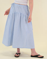 Woman wearing the Sabrina Skirt sewing pattern from BF Patterns on The Fold Line. A skirt pattern made in cotton lawn, batiste, poplin, or lightweight linen or linen blend fabric, featuring an elastic waistband, drawstrings, gently curved yoke, in-seam pockets, and above ankle length.