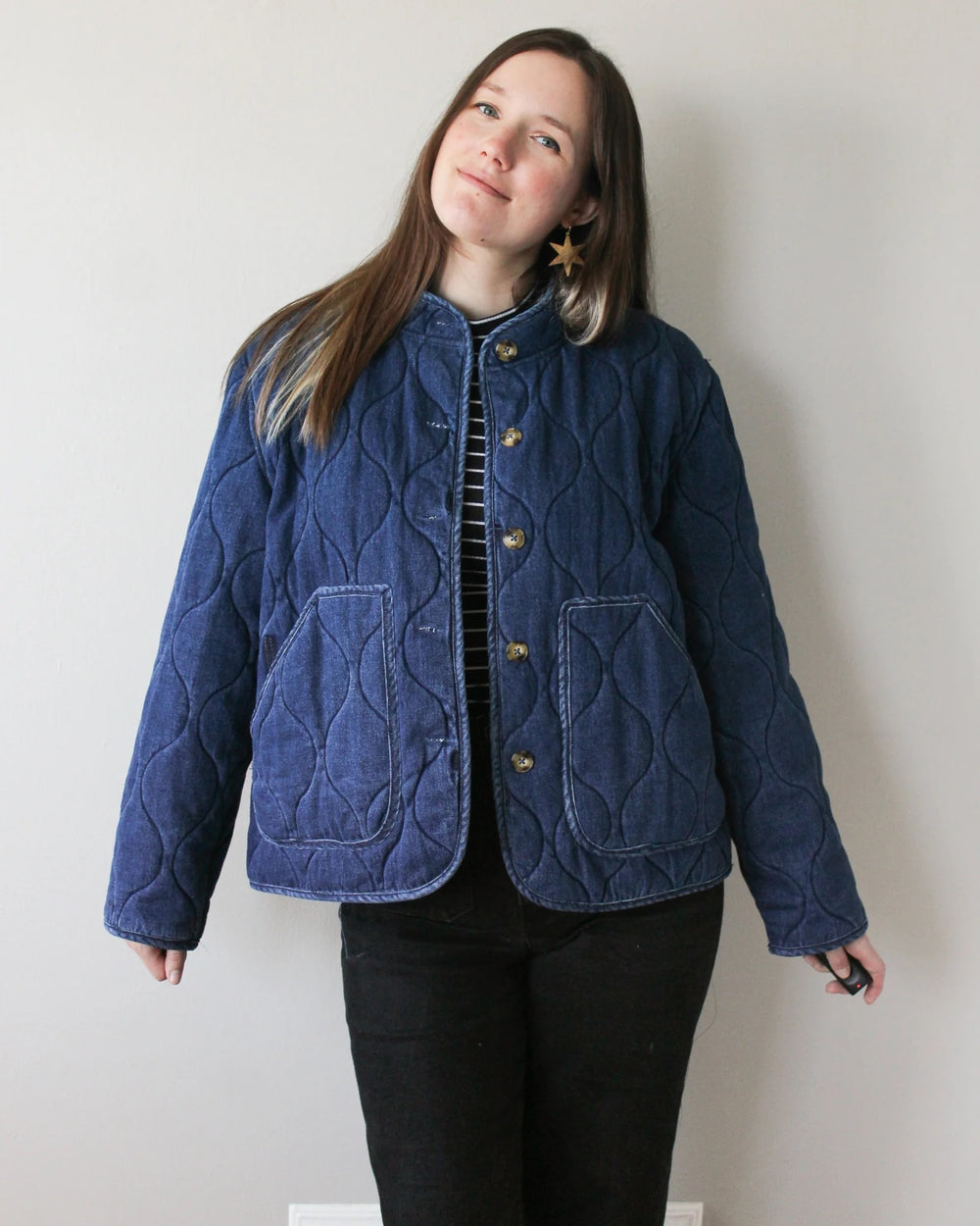 Woman wearing the Sage Coat sewing pattern from Oh Me Oh My Sewing on The Fold Line. A jacket pattern made in coating or pre-quilted fabric, featuring an oversized fit, patch pockets, and button closure.