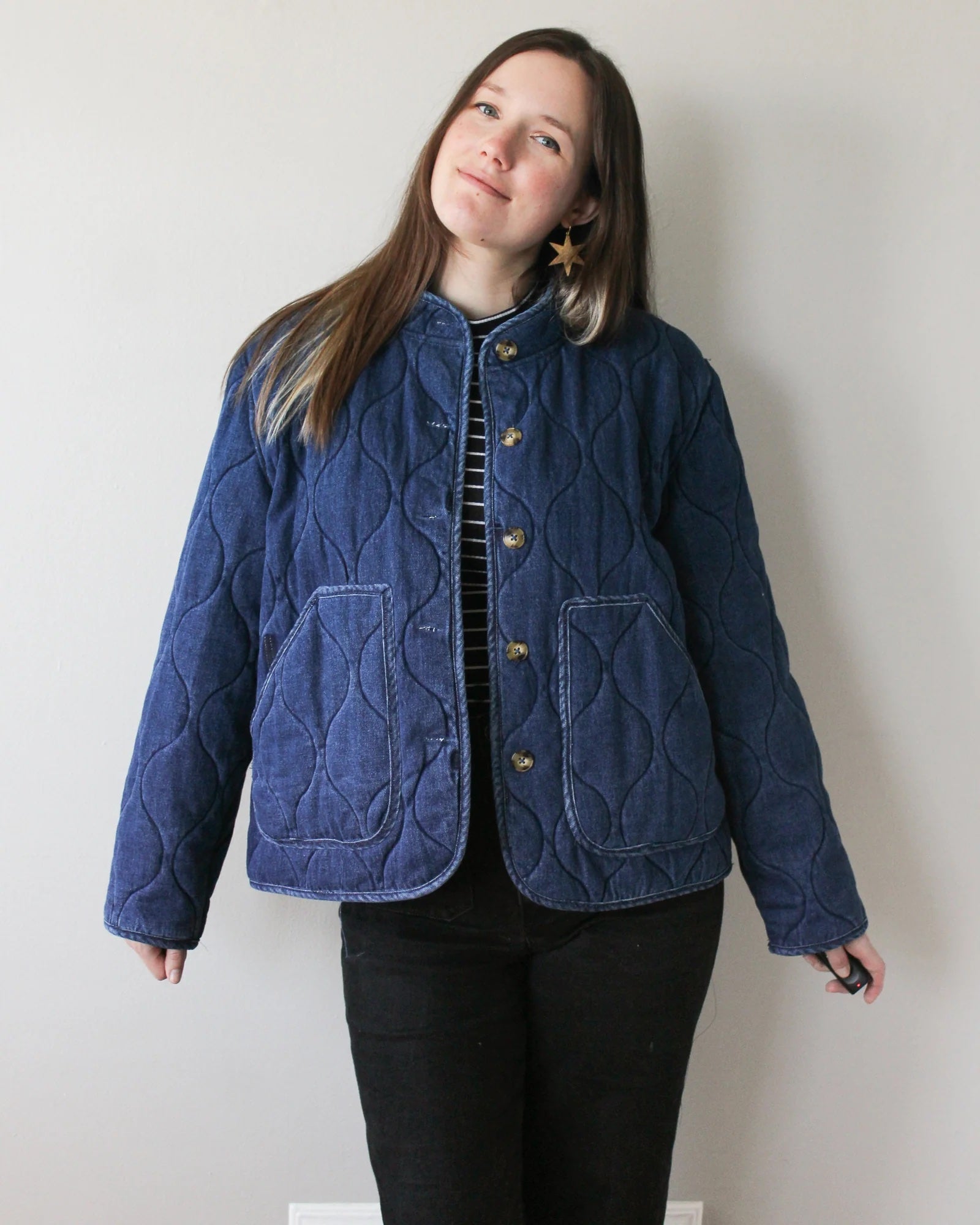 Woman wearing the Sage Coat sewing pattern from Oh Me Oh My Sewing on The Fold Line. A jacket pattern made in coating or pre-quilted fabric, featuring an oversized fit, patch pockets, and button closure.
