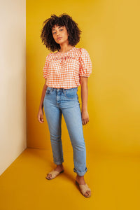 Woman wearing the Sagebrush Top sewing pattern from Friday Pattern Company on The Fold Line. A top pattern made in cotton voile, rayon challis, linen, silk, or cotton shirting fabric, featuring a relaxed fit, round neckline, short puff sleeves, and gathers and a ruffle across the front.