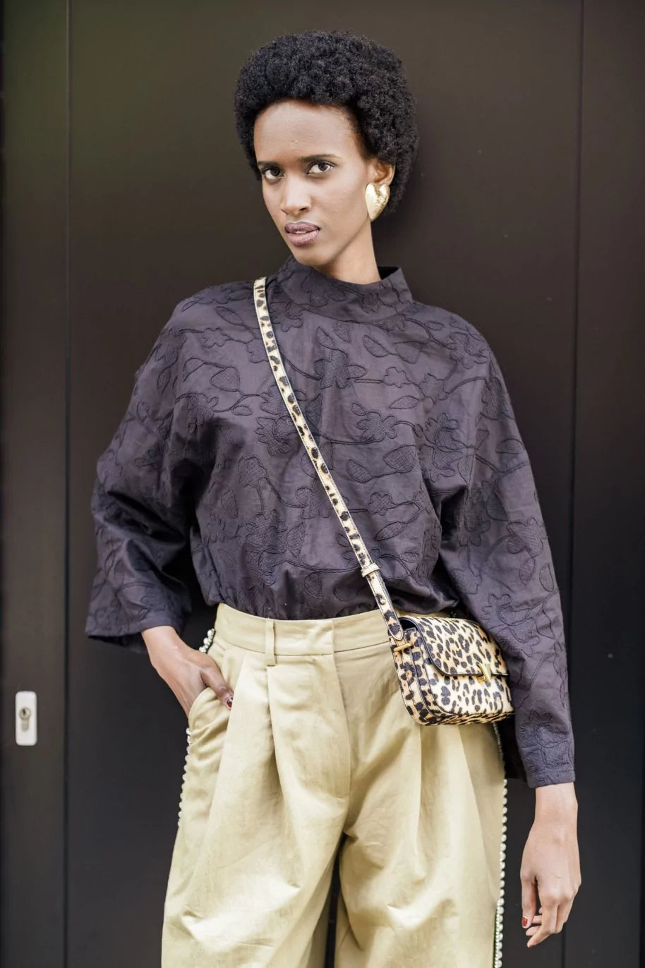 Woman wearing the Samira Top sewing pattern from Fibre Mood on The Fold Line. A top pattern made in viscose, lyocell, cupro, crepe, silk, satin, or light jacquard fabric, featuring a stand-up collar and wide sleeves. 