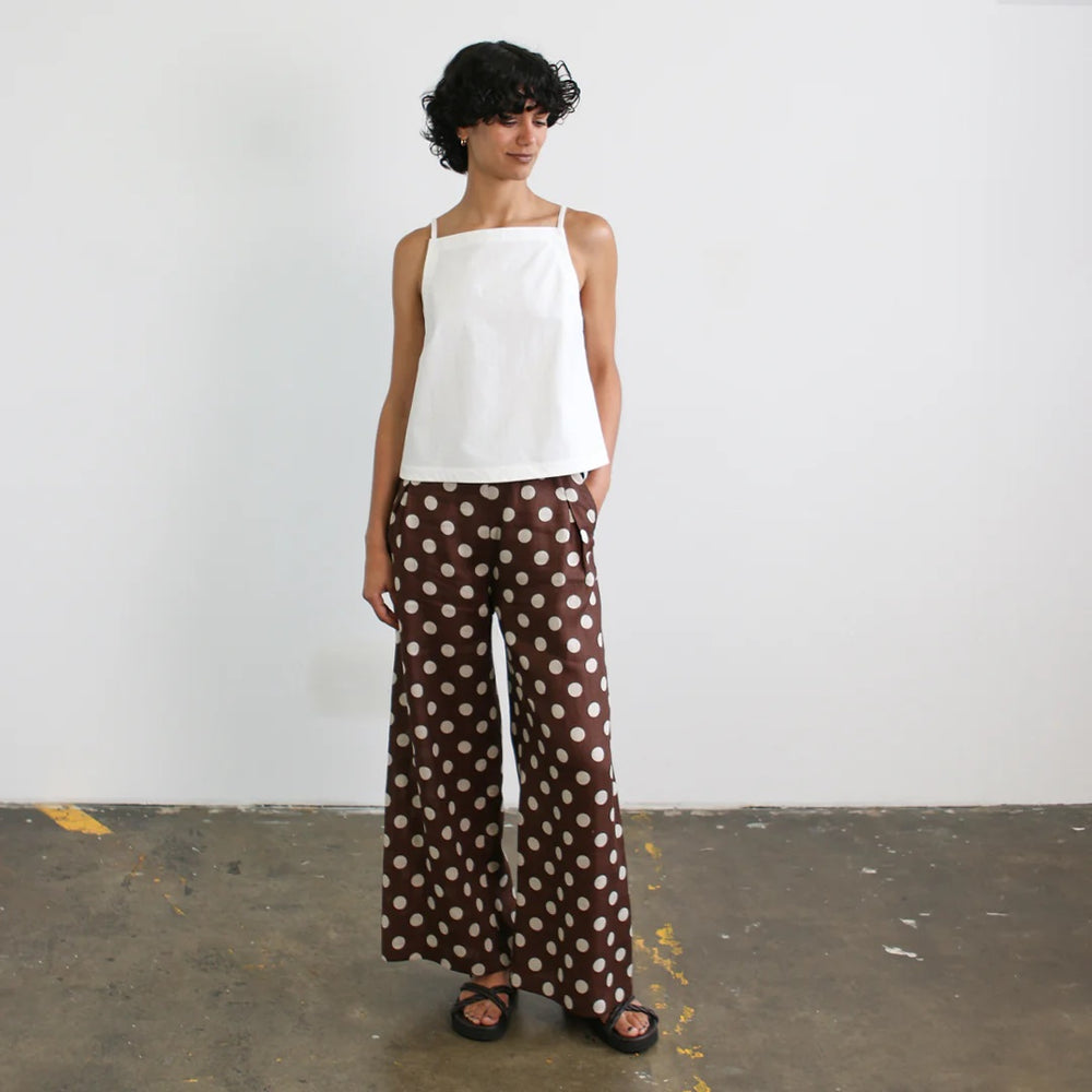 Woman wearing the Sammy Pants sewing pattern from Tessuti Fabrics on The Fold Line. A trousers pattern made in linen, linen/viscose, silk, rayon, viscose, or wool crepe fabric, featuring an elastic waist, stitched-down inverted pleats, wide legs, and side pockets.