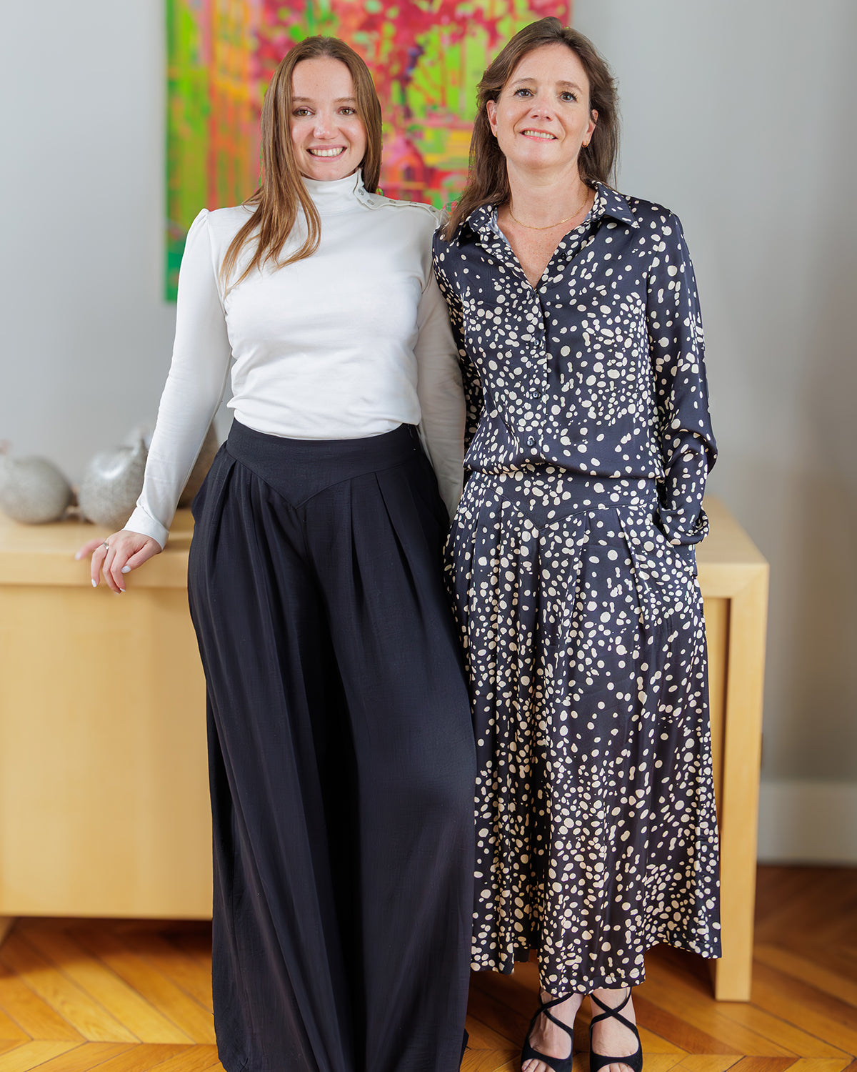Women wearing the Sanaz Culottes sewing pattern from Coralie Bijasson on The Fold Line. A culottes pattern made in viscose crepe or twill, cotton serge or poplin, tencel/lyocell, or linen/viscose fabric, featuring a shaped waistband with a triangular front detail, wide legs with pleats, slant pockets, side invisible zipper, and midi or full length.