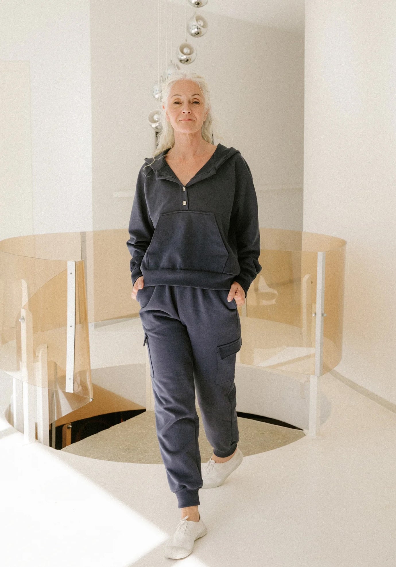 Woman wearing the Sasha Joggers sewing pattern from Maison Fauve on The Fold Line. A trousers pattern made in sweatshirt, jersey, or French terry fabric, featuring an elasticated waist, pockets, back yoke, straight leg, and ribbed cuffs.