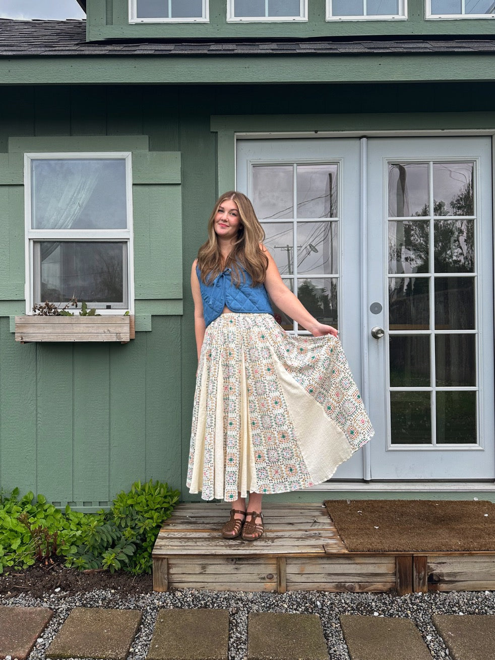 Woman wearing the Saundra Skirt sewing pattern from Syd Graham Patterns on The Fold Line. A skirt pattern made in lightweight woven fabric with drape, featuring an A-line shape, elastic waistband, godets, and pockets.