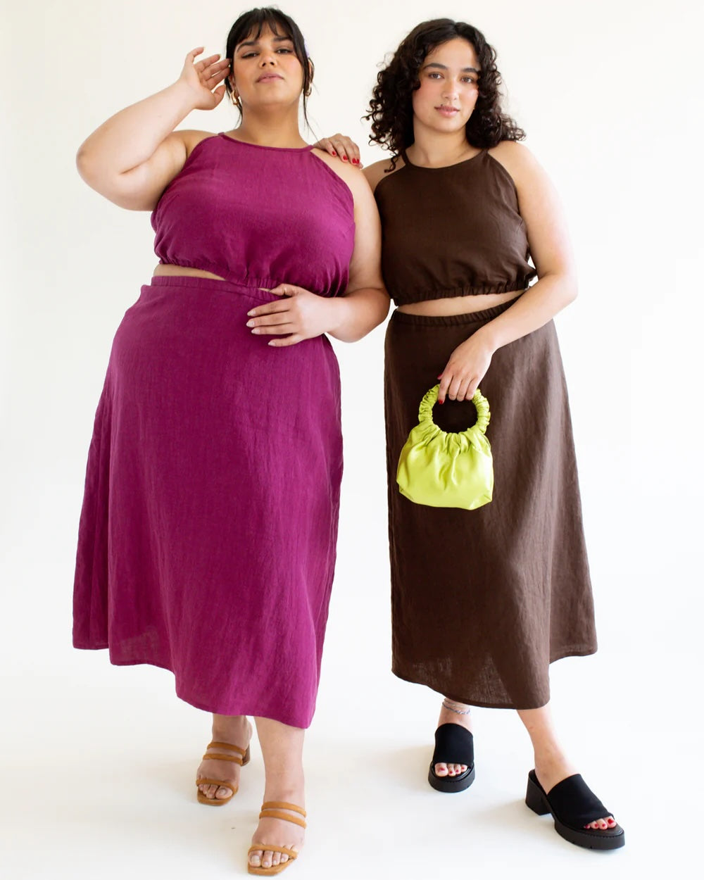 Women wearing the Selena Set sewing pattern from BF Patterns on The Fold Line. A top and skirt pattern made in linen, linen blend, rayon, viscose, silk noil, lyocell twill, cupro, or silk crepe fabric, featuring a semi-fitted strappy sleeveless top with an elastic waistband at the natural waist, and an A-line midi skirt with an elastic waist and back invisible zipper closure, which can be connected at the front to make a dress.