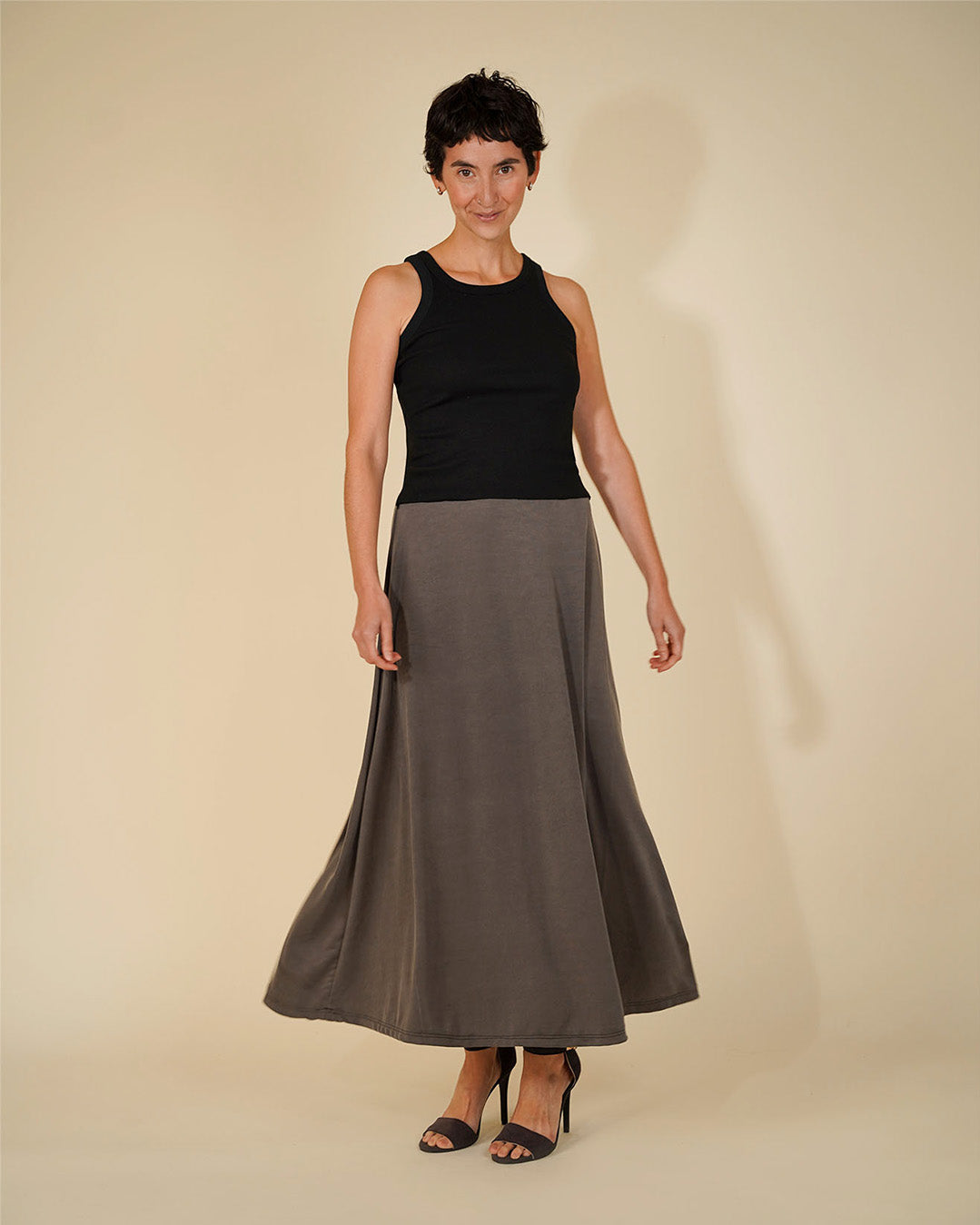 Woman wearing the Simple A-line Skirt sewing pattern from Wardrobe by Me on The Fold Line. A skirt pattern made in jersey fabric, featuring an A-line silhouette, elasticated waist, and ankle length.