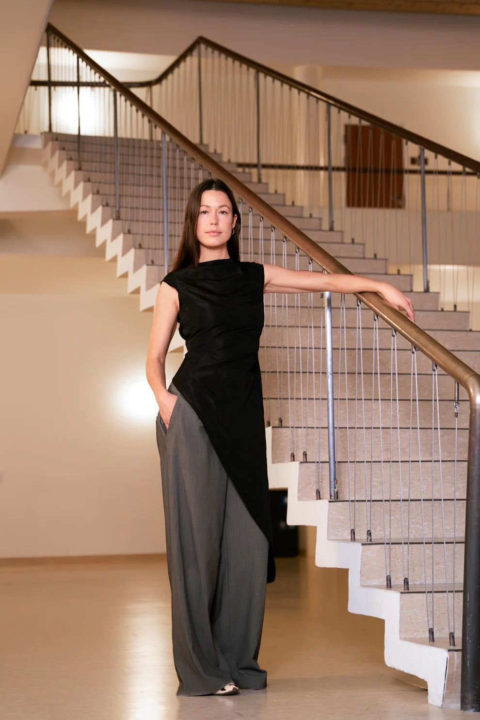 Woman wearing the Slash Dress & Cap Sleeve sewing pattern bundle from Puff and Pencil on The Fold Line. Dress and sleeve patterns made in taslan, linen, lightweight wool, lightweight denim, velvet, or cotton twill fabric, featuring a fitted silhouette, slash neckline, cap sleeves, and asymmetrical hemline.