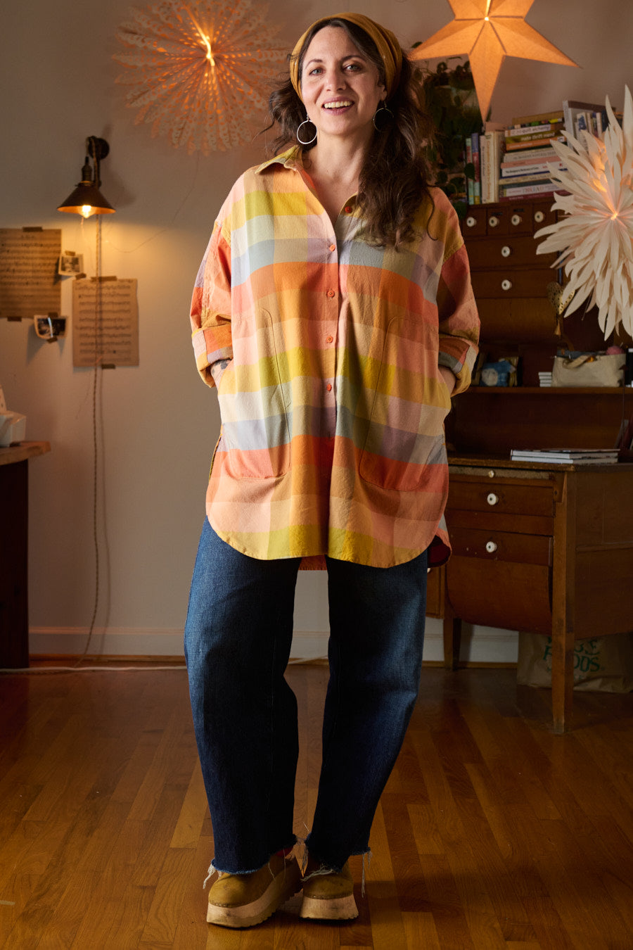 Woman wearing the Slow Shirt sewing pattern from Sew Liberated on The Fold Line. A shirt pattern made in poplin, plain weave cotton or linen or tencel, flannel, chambray, or light twill fabric, featuring an oversized fit, dropped shoulders, collar with a stand, button front, long sleeves with cuffs, front pockets, and mid-thigh length.