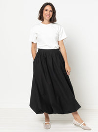 Woman wearing the Sophia Woven Bubble Skirt sewing pattern from Style Arc on The Fold Line. A lined skirt pattern made in twill, poplin, or linen fabric, featuring a flat front waistband, elastic back waistband, in-seam pockets, and maxi length.