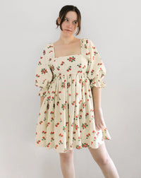 Woman wearing the Sophie Dress sewing pattern from Oh Me Oh My Sewing on The Fold Line. A dress pattern made in quilting cotton, washed linen, cotton lawn, voile, or organza fabric, featuring a square neckline with elastic shoulders, lined bodice, mid-length puff sleeves, invisible zipper closure, gathered skirt, and above-the-knee length.