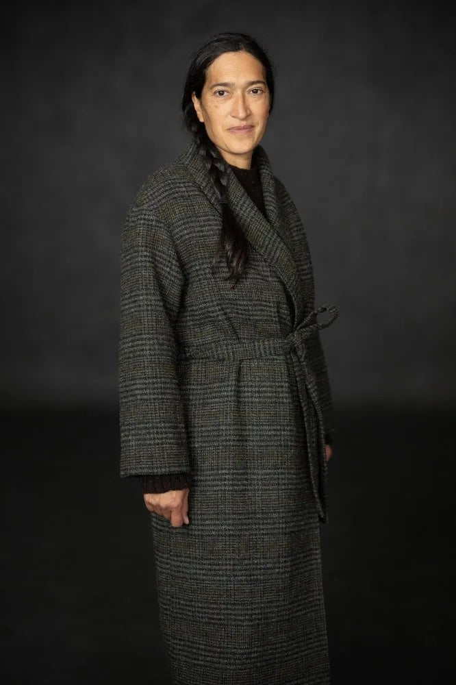Woman wearing the Sunday Coat Addition sewing pattern from Merchant & Mills on The Fold Line. A lined coat pattern made in wool or tweed fabric, featuring a shawl collar, wrap front, tie belt, and in-seam pockets.