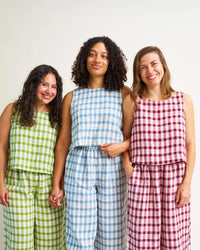 Women wearing the Sunny Side Tank sewing pattern from Matchy Matchy Sewing Club on The Fold Line. A sleeveless top pattern made in linen, cotton lawn, or rayon fabric, featuring a relaxed fit, round neckline, A-line shape, and cropped length.