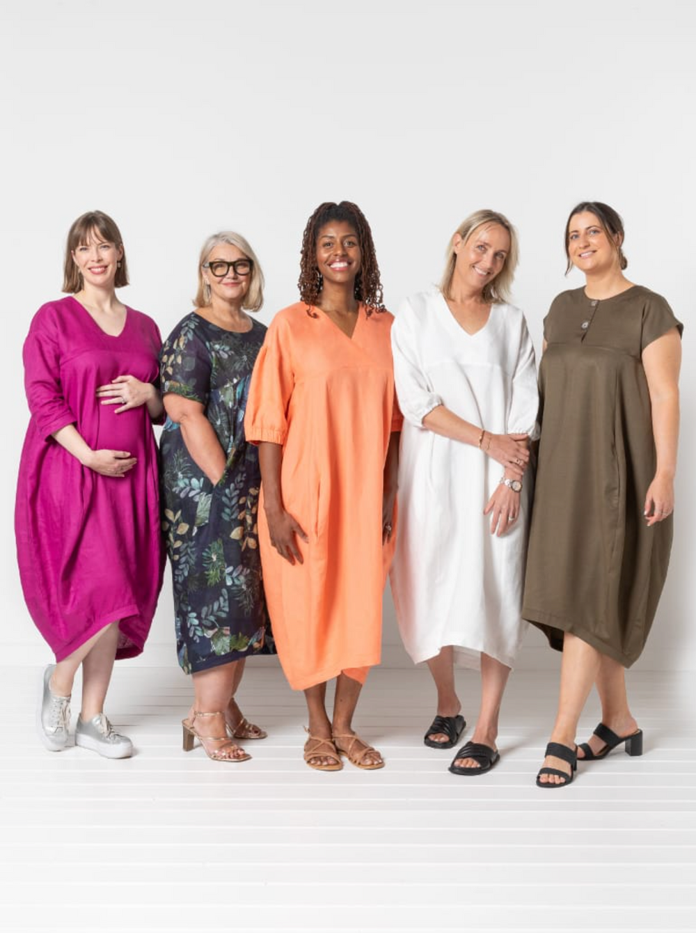Women wearing the Sydney Dress Extension Pack sewing pattern from Style Arc on The Fold Line. A cocoon dress pattern made in washed linen, crepe, rayon, or lightweight wool fabric, featuring a round or V-neckline, short or mid length sleeves, and a midi length.
