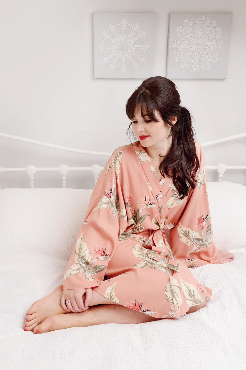 Woman wearing the Sylvia Robe Dressing Gown Add-on sewing pattern from Sew Over It on The Fold Line. A dressing gown pattern made in viscose, silk, crepe, waffle, or light terry towelling fabric, featuring a wrap silhouette with a tie belt. 