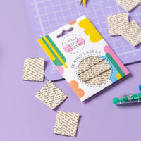 The 'This Is the Back' woven labels from Little Rosy Cheeks on The Fold Line. The pack includes 6 organic cotton labels with black typewriter-style text on a cream background, ready to be sewn into your handmade clothes.