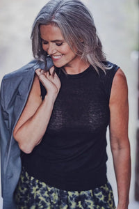 Woman wearing the Tiany Top sewing pattern from Fibre Mood on The Fold Line. A sleeveless top pattern made in knit fabric, featuring a fitted silhouette and round neckline.