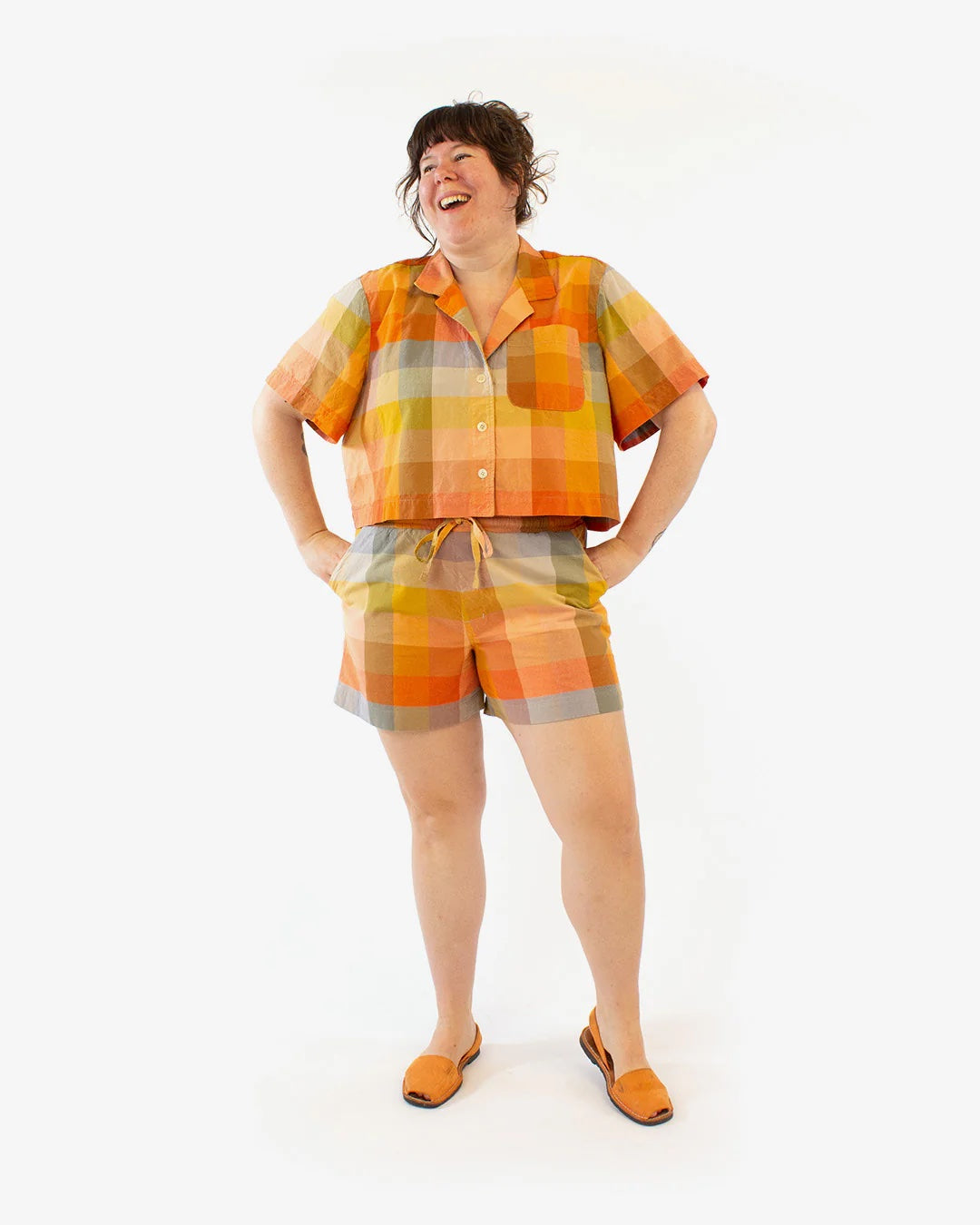 Woman wearing the Tofino Top sewing pattern from Helen's Closet on The Fold Line. A shirt pattern made in cotton, linen, rayon/viscose challis or poplin, or tencel fabric, featuring an oversized fit, camp collar, dropped shoulders, short sleeves, button front, and cropped length.