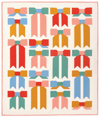 The Top Knot Quilt sewing pattern from Pen + Paper Patterns on The Fold Line. A quilt pattern made in quilting cotton fabric, featuring a traditionally pieced bow motif. 