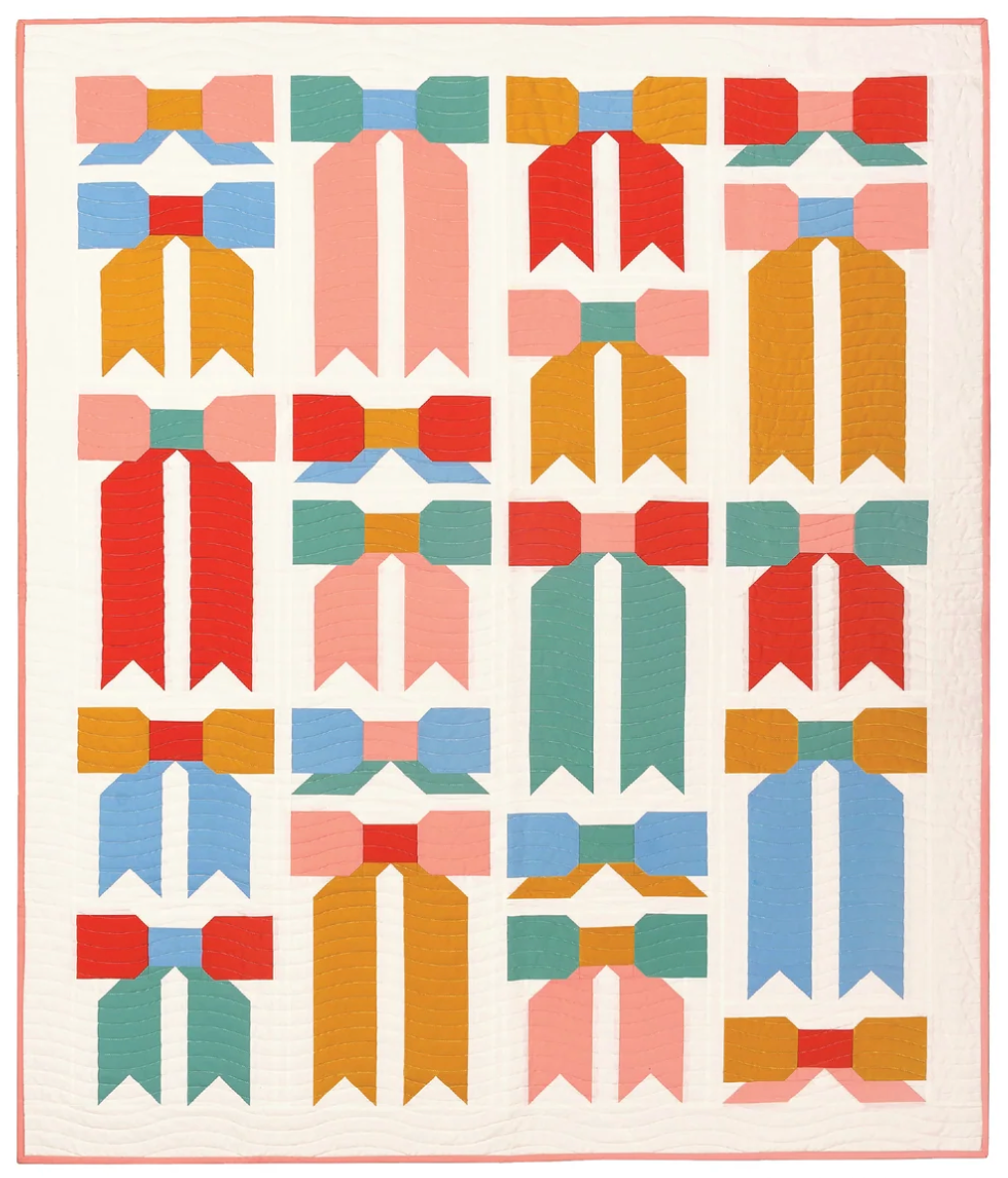 The Top Knot Quilt sewing pattern from Pen + Paper Patterns on The Fold Line. A quilt pattern made in quilting cotton fabric, featuring a traditionally pieced bow motif. 