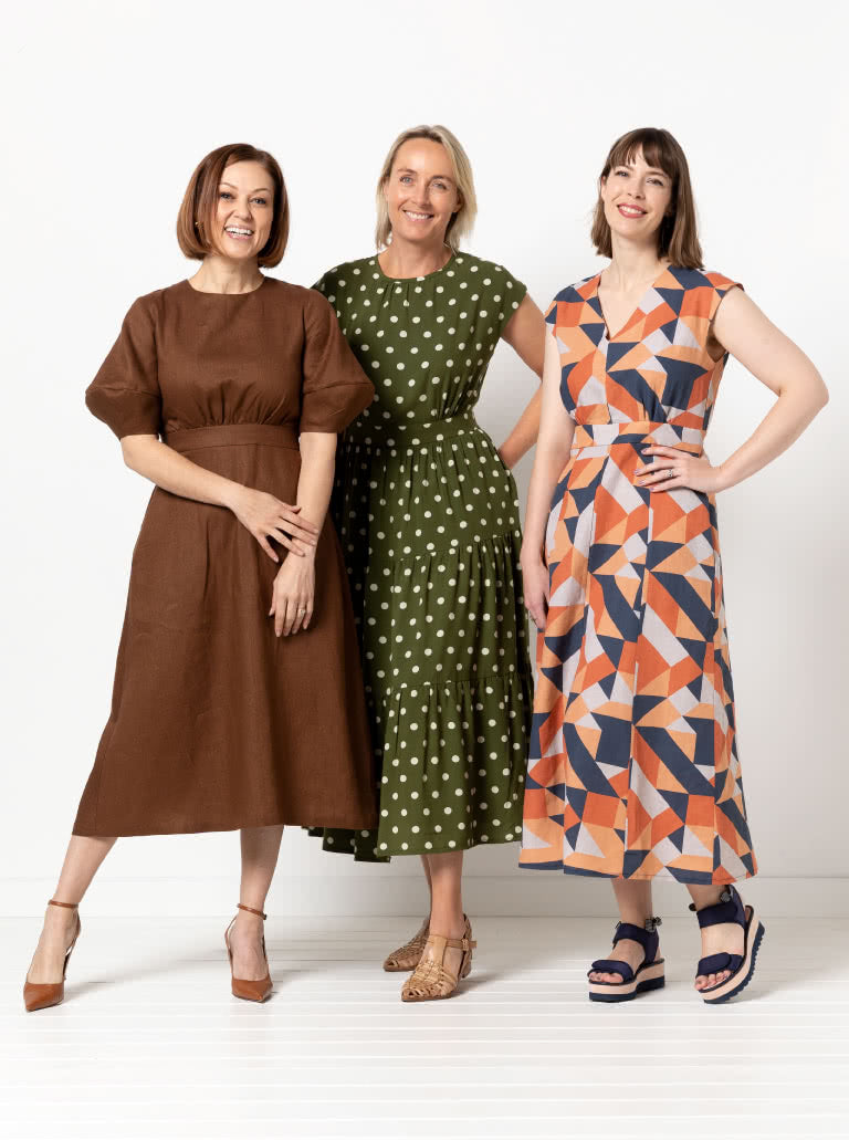 Women wearing the Trinnie Dress Extension Pack sewing pattern from Style Arc on The Fold Line. A dress pattern made in linen, crepe, silk, rayon, or cotton fabric, featuring a round or V-neckline, sleeveless or lantern sleeve, A-line, gathered or panelled skirt, and midi length.