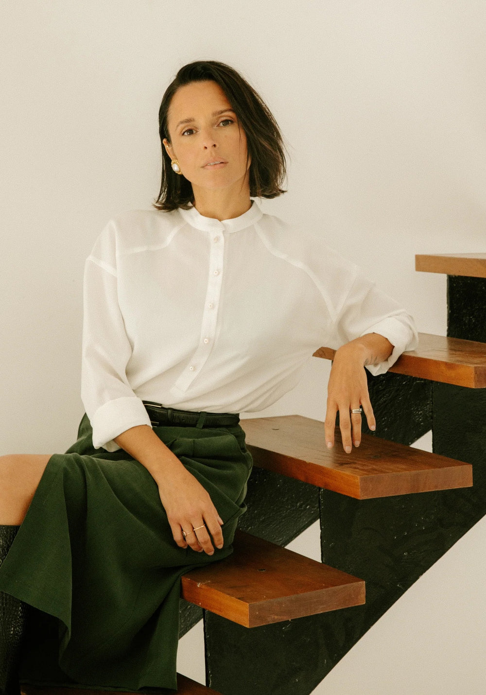 Woman wearing the Vittoria Shirt sewing pattern from Maison Fauve on The Fold Line. A shirt pattern made in poplin, voile, crepe, cotton, tencel, viscose, linen, lightweight denim, or soft jacquard fabric, featuring a relaxed fit, dropped shoulders, band collar, and polo-style button placket.