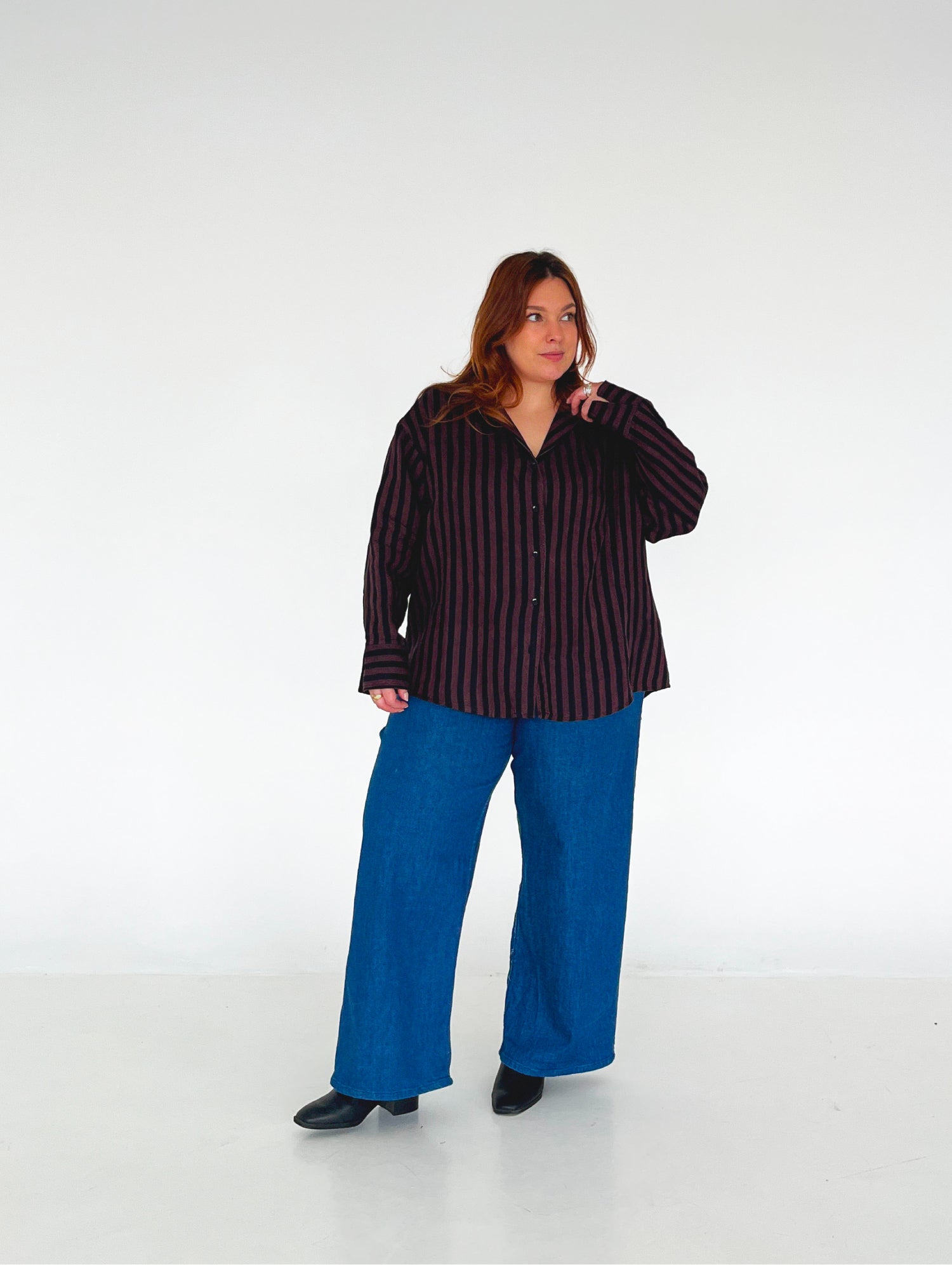 Woman wearing the Weekday Shirt sewing pattern from Les Perlines on The Fold Line. A shirt pattern made in cotton, linen, rayon, viscose, or tencel twill fabric, featuring an oversized boyfriend fit, dropped shoulders, long sleeves, camp collar, button front, and curved hem.