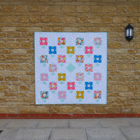 The Wildflower Meadow Quilt sewing pattern from Lou Orth Designs on The Fold Line. A quilt pattern made in quilting cotton fabric, featuring flower blocks arranged on point.