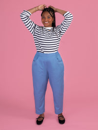 Woman wearing the Winnie Trousers sewing pattern from Tilly and the Buttons on The Fold Line. A trousers pattern made in cotton twill, chambray, washed linen, double gauze, or needlecord fabric, featuring a high waist, flat-fronted elasticated waistband, pockets, barrel leg, and ankle length.