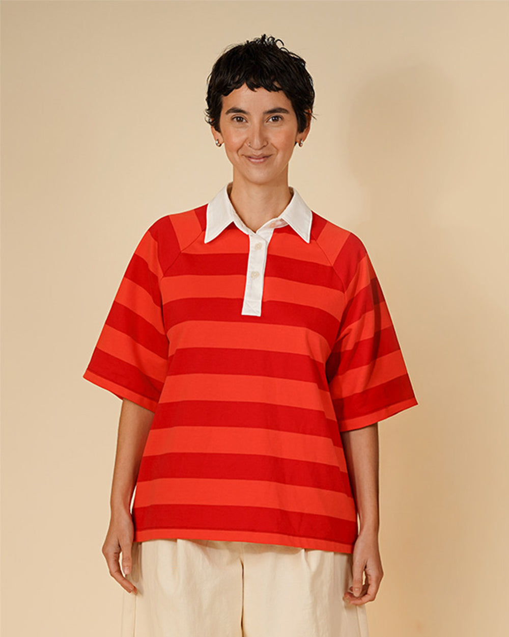 Woman wearing the Women's Rugby Shirt sewing pattern from Wardrobe by Me on The Fold Line. A top pattern made in medium weight jersey or lightweight woven fabric, featuring a shirt collar and stand, three-button placket, and big elbow-length raglan sleeves.