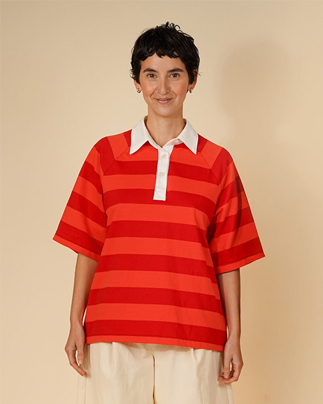 Woman wearing the Women's Rugby Shirt sewing pattern from Wardrobe by Me on The Fold Line. A top pattern made in medium weight jersey or lightweight woven fabric, featuring a shirt collar and stand, three-button placket, and big elbow-length raglan sleeves.