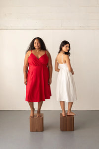 Women wearing the Wren Wrap Dress sewing pattern from Friday Pattern Company on The Fold Line. A dress pattern made in rayon challis, silk, lawn, voile, or linen fabric, featuring a V-neckline, lined bodice, adjustable spaghetti straps, panelled skirt with gathering on the sides, and below-knee length.