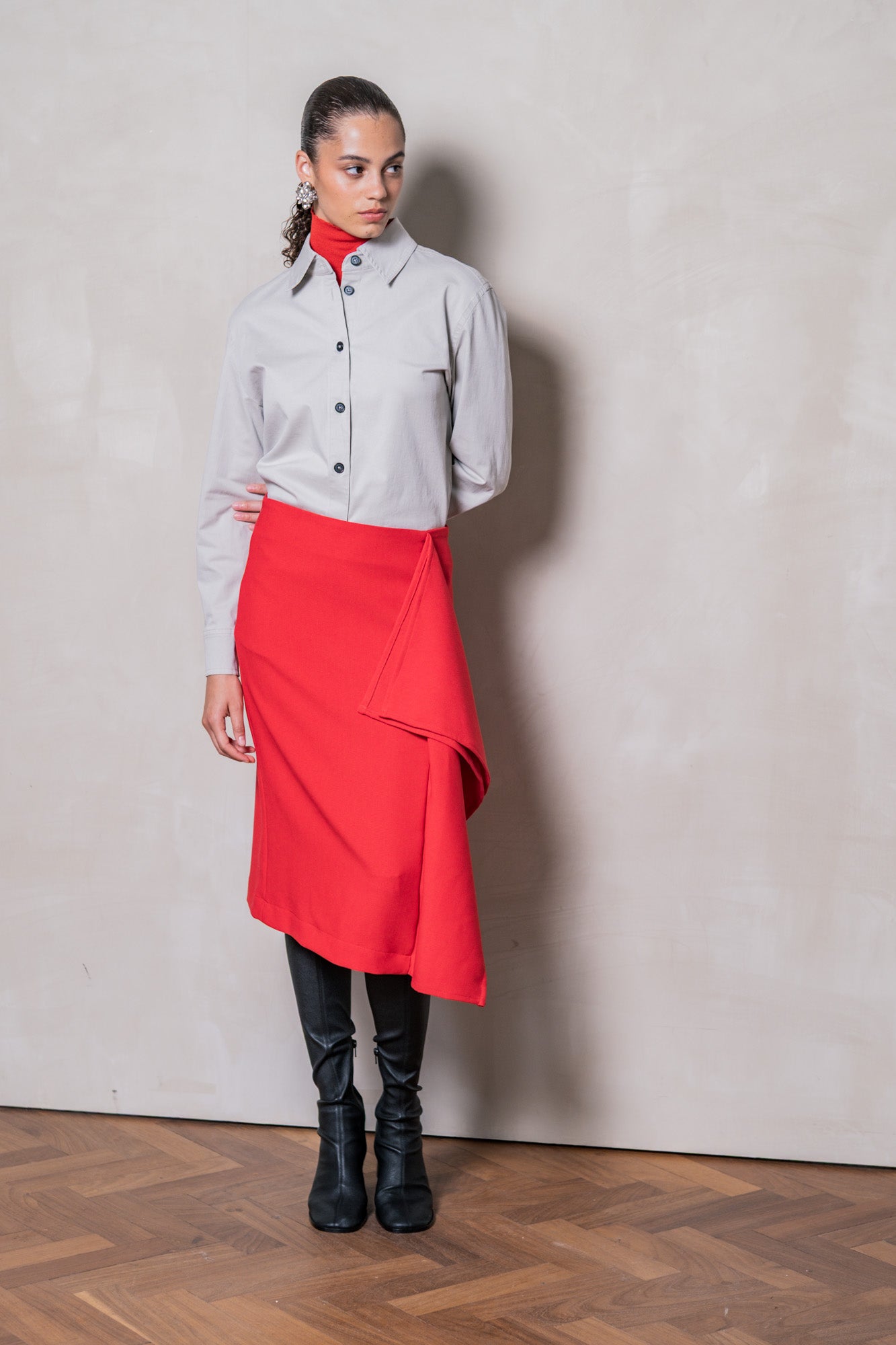 Woman wearing the Yuna Skirt sewing pattern from Fibre Mood on The Fold Line. A pencil skirt pattern made in denim, corduroy, cotton twill, cotton sateen, lightweight wool, linen, chambray, crepe, or lyocell fabric, featuring a cascading front panel and back slit.